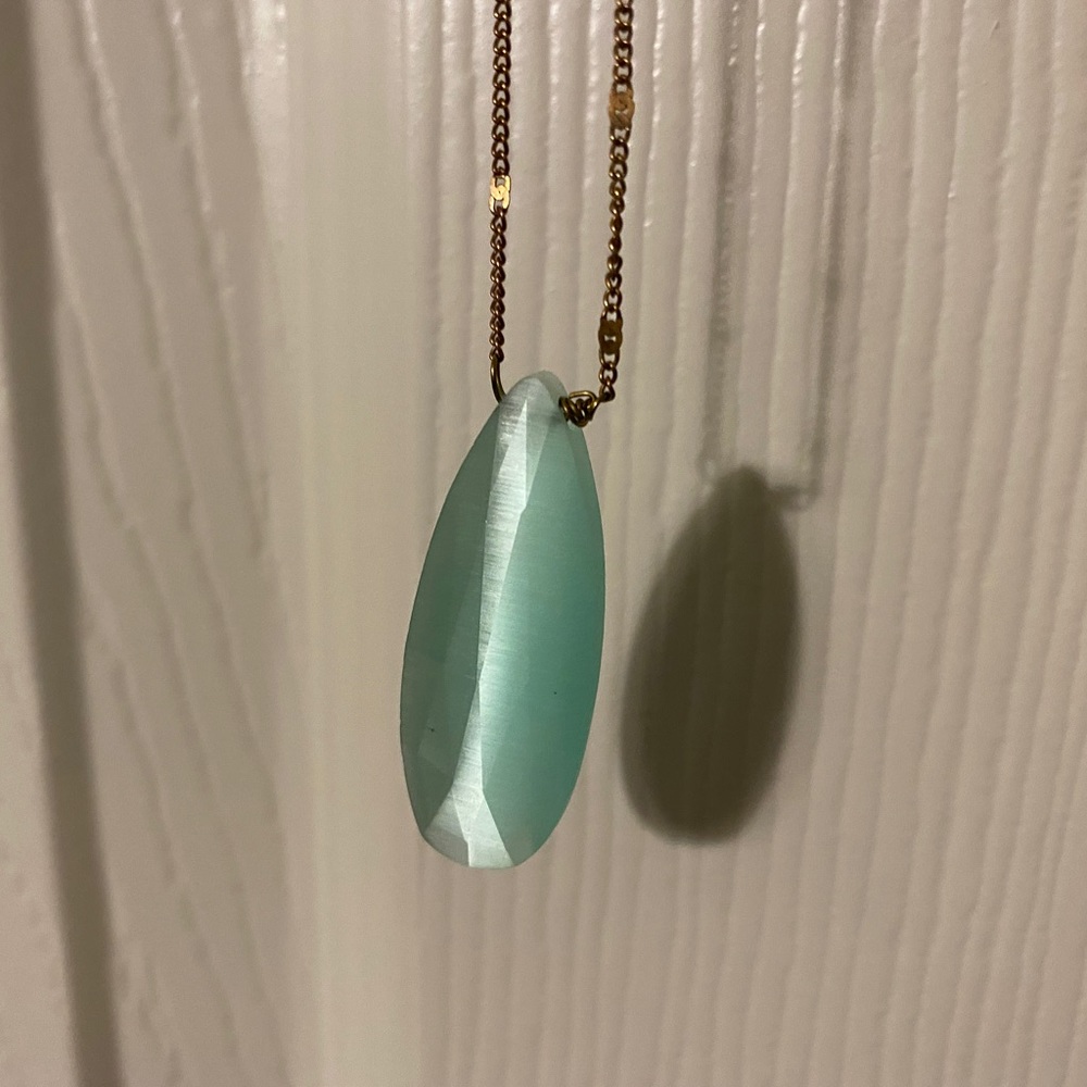 Long gold necklace with teal charm
